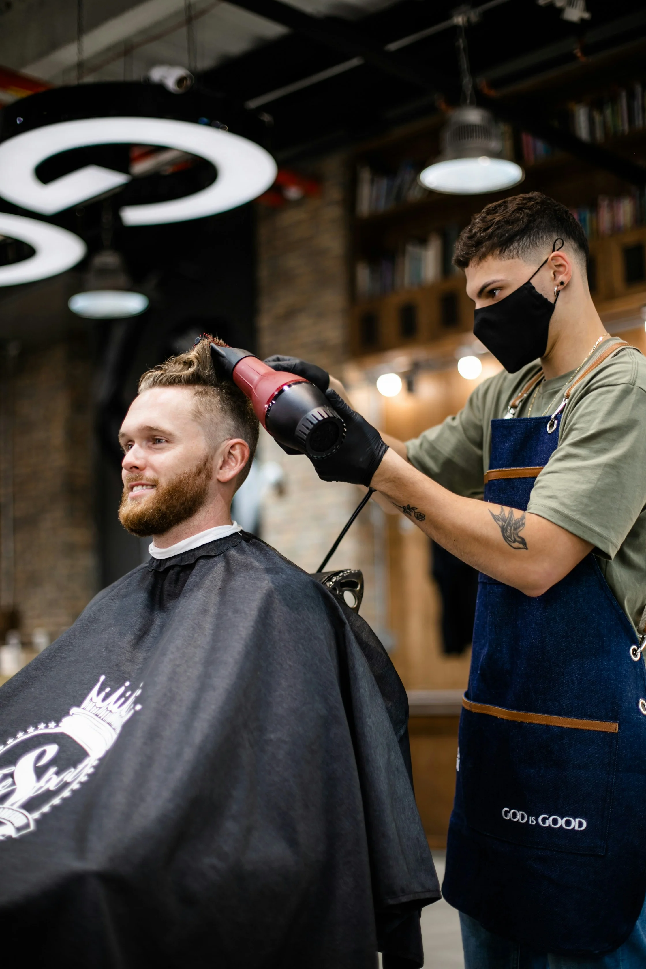 Independent barber finishing a client's haircut