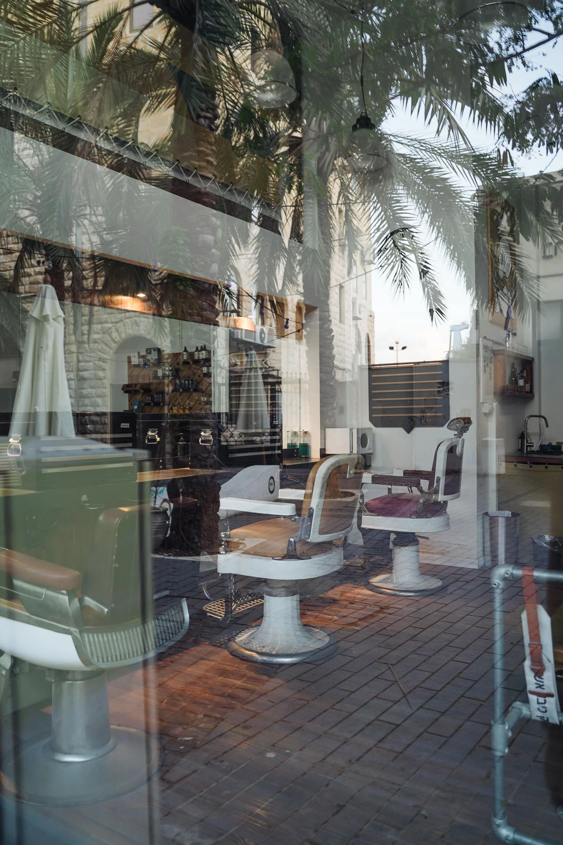 Illustrative real barbershop interior seen through a window