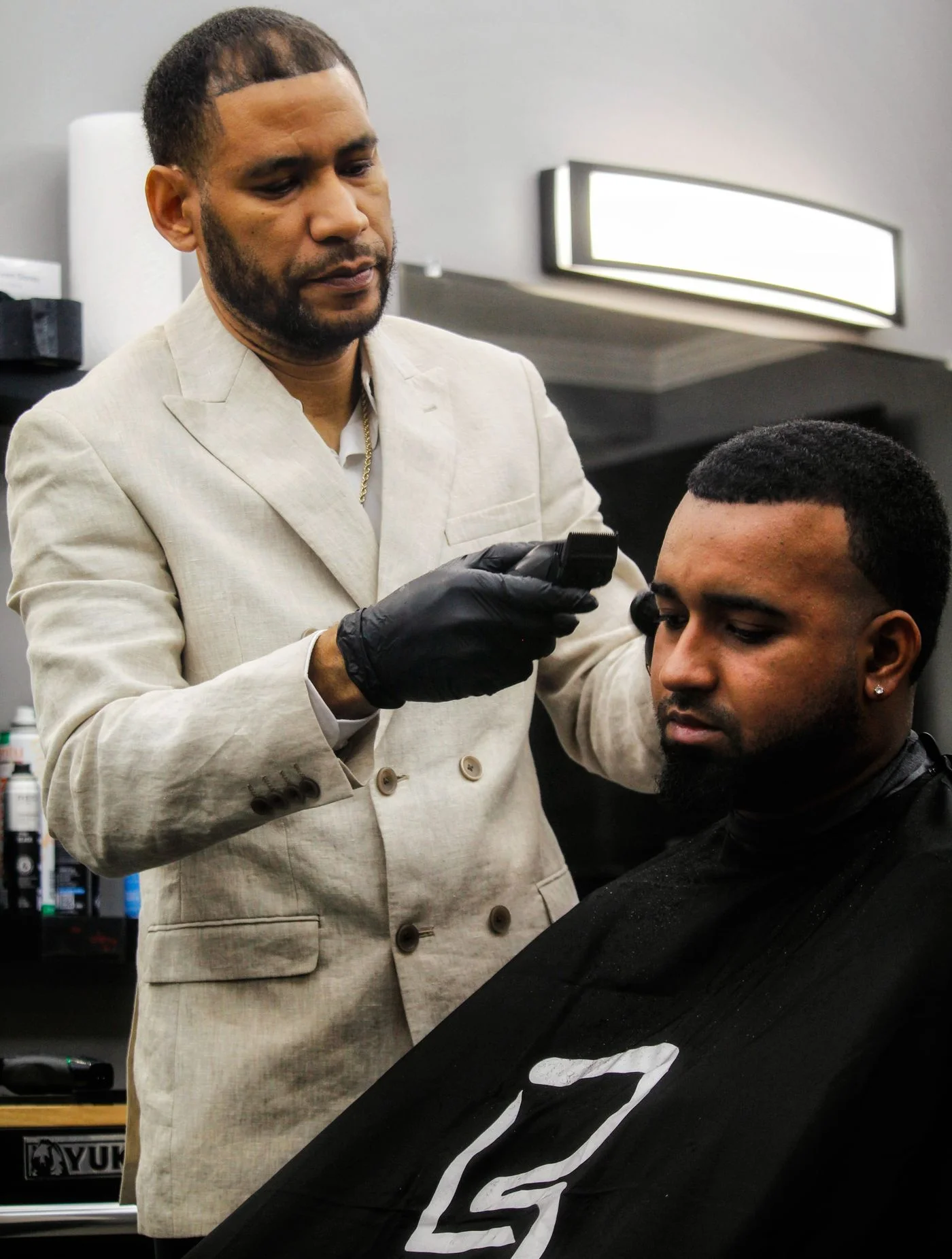 Barber shaping a client's haircut