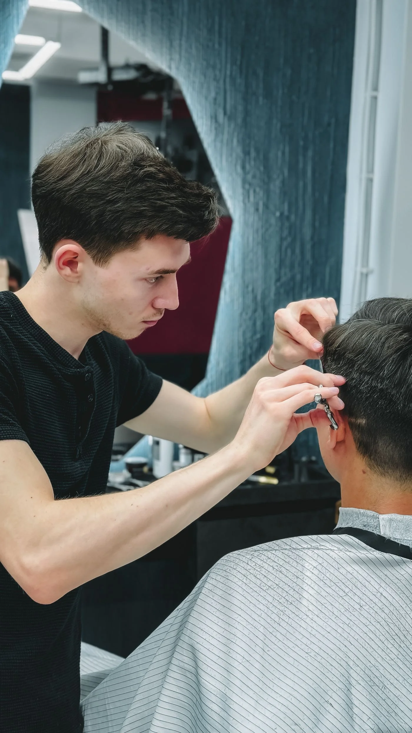 A barber detailing a haircut